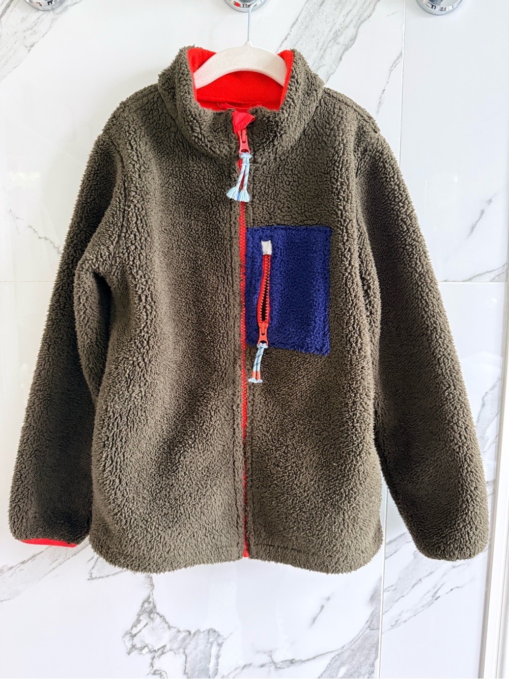 mini boden kids wind proof fleece jacket in olive with blue pocket